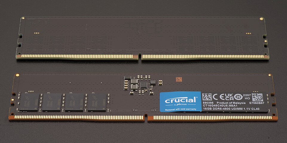 A DDR5 RAM DIMM module showing the memory chips along the top edge and the gold edge connector along the bottom